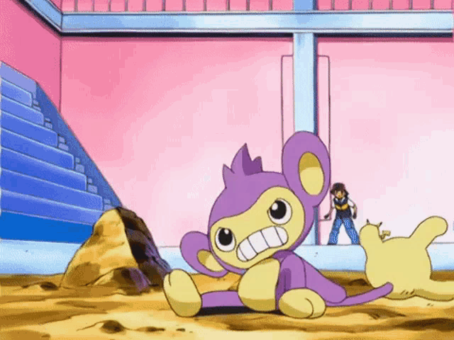 a purple and yellow monkey is sitting in the dirt with a man standing in the background .