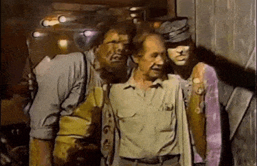 a group of men are standing next to each other in a dark room .