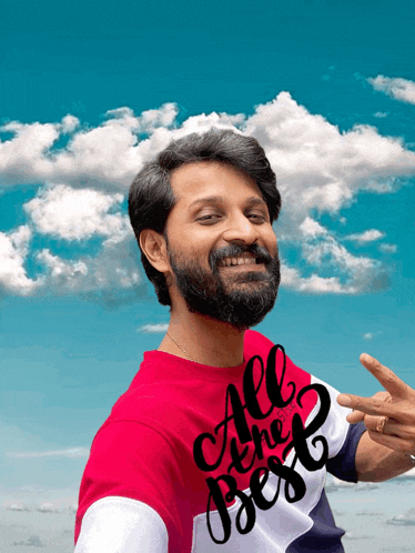 a man with a beard is wearing a red shirt that says all the best