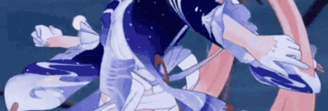 a close up of a person in a blue and white dress holding a sword .
