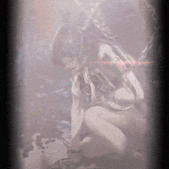 a woman is kneeling down in a dark room with a red light shining on her