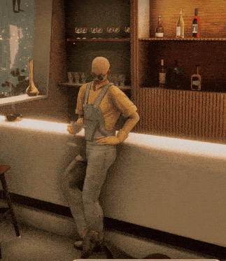 a man in overalls leans against a bar holding a drink