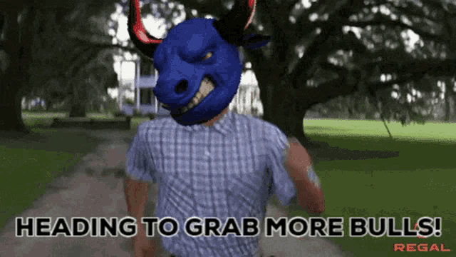 a man with a blue bull mask on his head is heading to grab more bulls