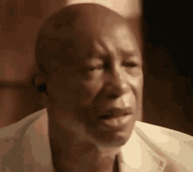 a close up of a man 's face with his eyes closed and his mouth open .