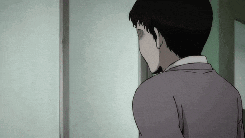 a man in a suit is standing in front of a door with his eyes closed