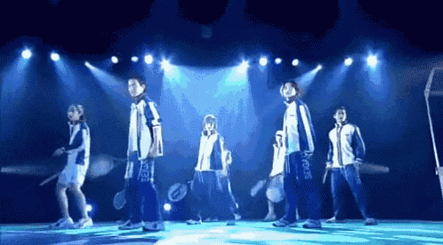 a group of people on a stage with the word sports on their uniforms