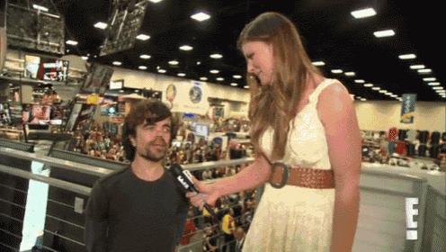 a man is being interviewed by a woman with a microphone that says cnn on it