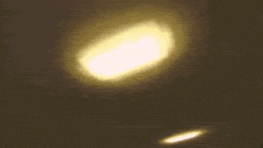 a close up of a cartoon character with a light coming out of her eyes .