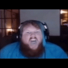 a man with a beard is wearing headphones and making a face .