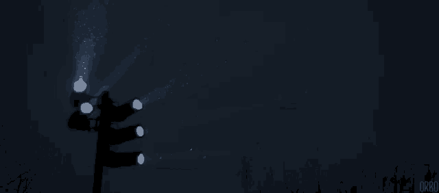 a traffic light is lit up in the dark and says orbo on the bottom left