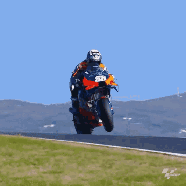 a man riding a motorcycle with the number 883 on it