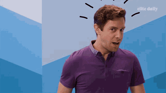a man in a purple shirt stands in front of a blue wall that says elite daily on it
