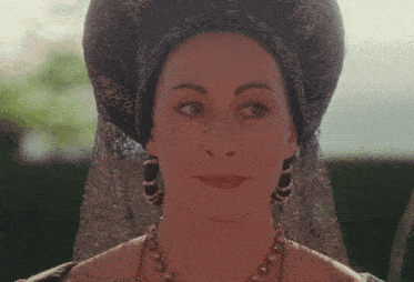 a woman with a veil on her head and a necklace