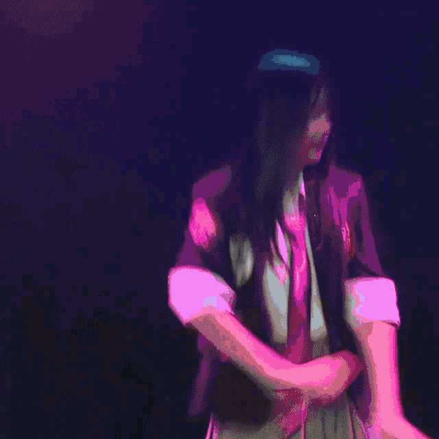 a blurry picture of a person dancing with a blue light behind them