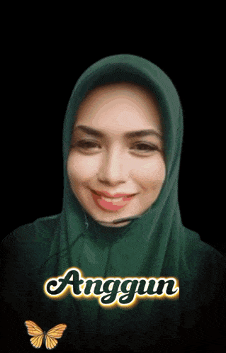 a woman wearing a green hijab with the name anggun written on it