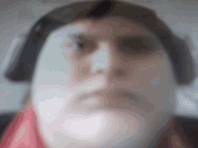 a close up of a person 's face with headphones on .