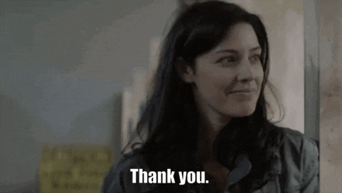 a woman is smiling and saying thank you in a video .