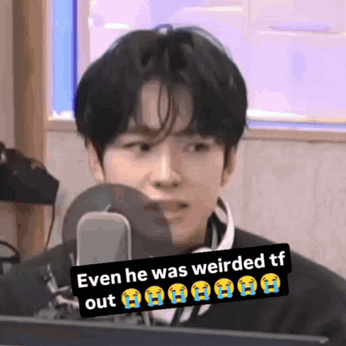 a young man is sitting in front of a microphone with a caption that says even he was weirded out