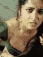 a close up of a woman 's face with a green shirt