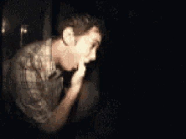 a man in a plaid shirt is drinking a cup of coffee