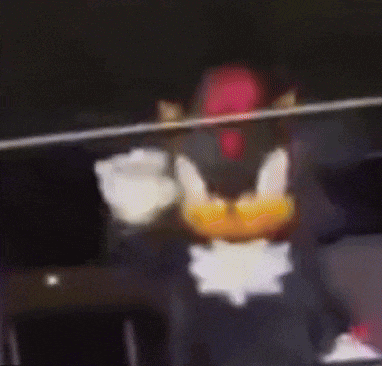 a close up of a lego shadow the hedgehog standing in front of a microphone .