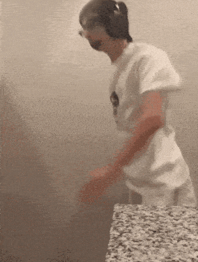 a man wearing headphones is dancing in a bathroom