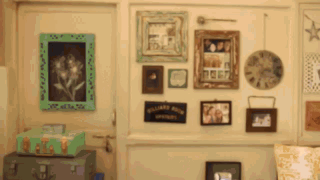a wall filled with pictures and a sign that says billiard room