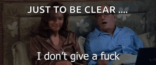 a man and a woman are sitting on a bed with the words just to be clear i do n't give a fuck
