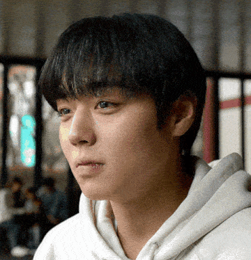 a close up of a man 's face with a white hoodie on