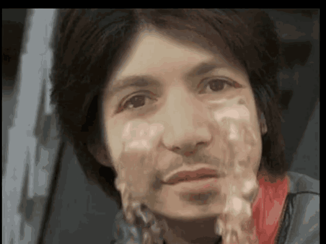a close up of a man 's face with a woman 's face on it