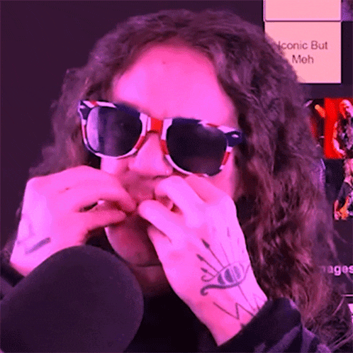 a person wearing sunglasses has a tattoo on their arm that says iconic but meh