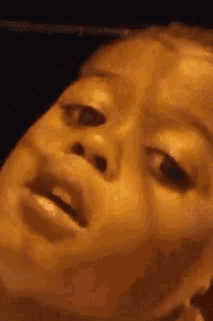 a close up of a woman 's face making a funny face with her mouth open .