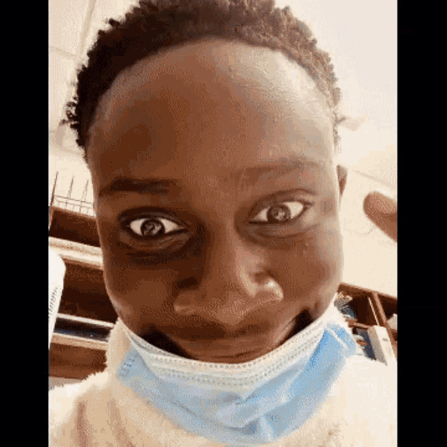a close up of a person wearing a mask and making a funny face