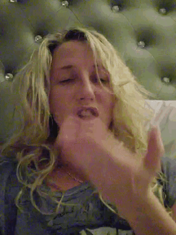 a woman is laying on a bed with her eyes closed