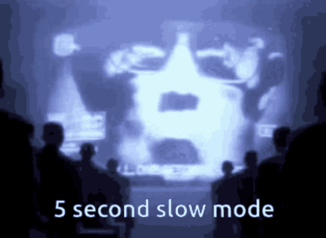 a group of people looking at a screen that says 5 second slow mode on it