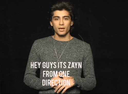 a young man wearing a grey sweater stands in front of a black background and says hey guys its zayn from one direction