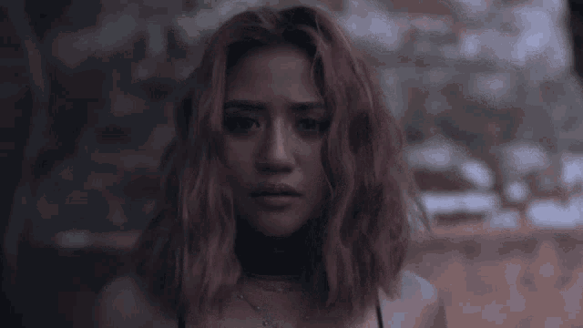 a woman with pink hair is wearing a choker