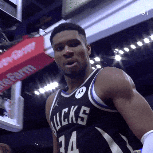 a basketball player wearing a black bucks jersey