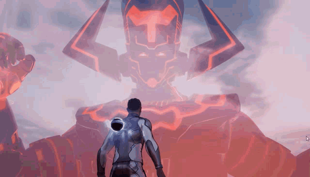 a man is standing in front of a giant robot with a t on its head
