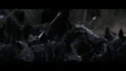 a group of soldiers holding swords and shields in the dark .