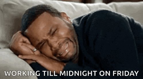 a man is crying while laying on a couch and the caption says `` working till midnight on friday '' .