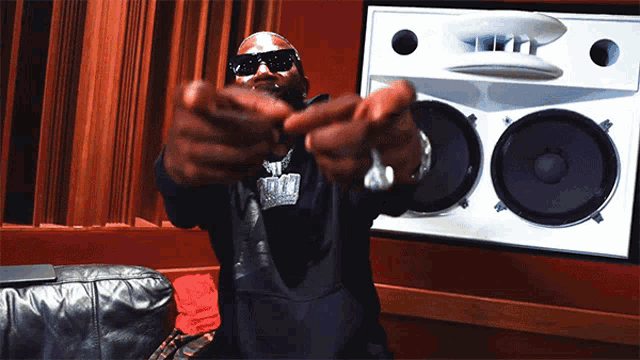 a man wearing sunglasses and a sweater that says ' snoop dogg ' on it