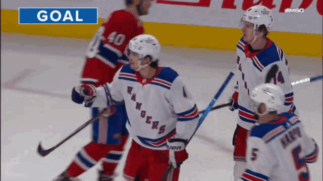 a hockey game is being played and the goal is shown on the screen