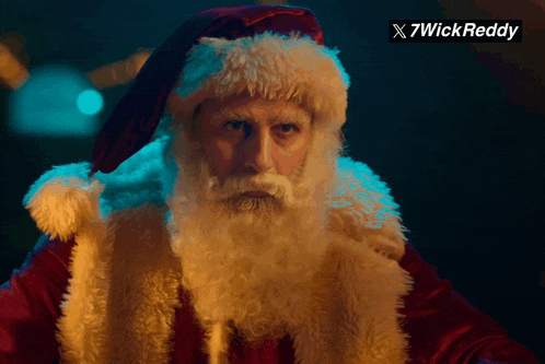 a picture of a man dressed as santa claus with a x7wick reddy watermark