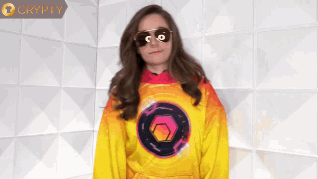 a woman wearing sunglasses and a yellow shirt with a circle on the front