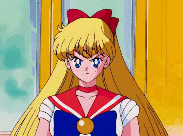 a girl with long blonde hair is wearing a sailor uniform