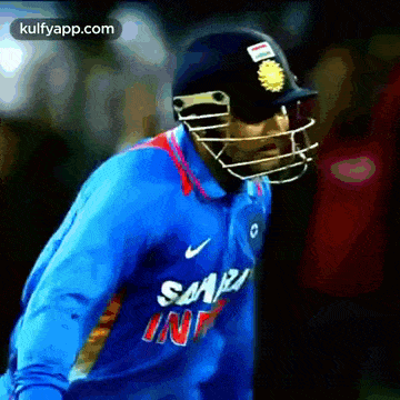 a cricket player wearing a helmet and a shirt that says samsung