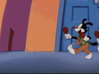 a group of cartoon characters are standing next to each other in front of a blue door .