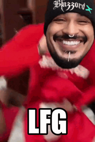 a man with a beard wearing a black beanie with the word blazord on it