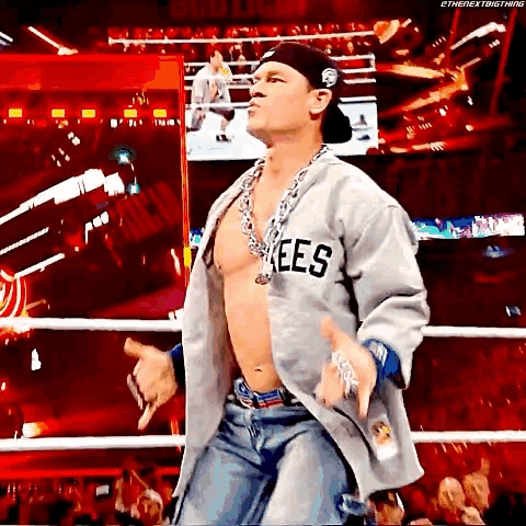 a shirtless wrestler wearing a jersey that says rees on it